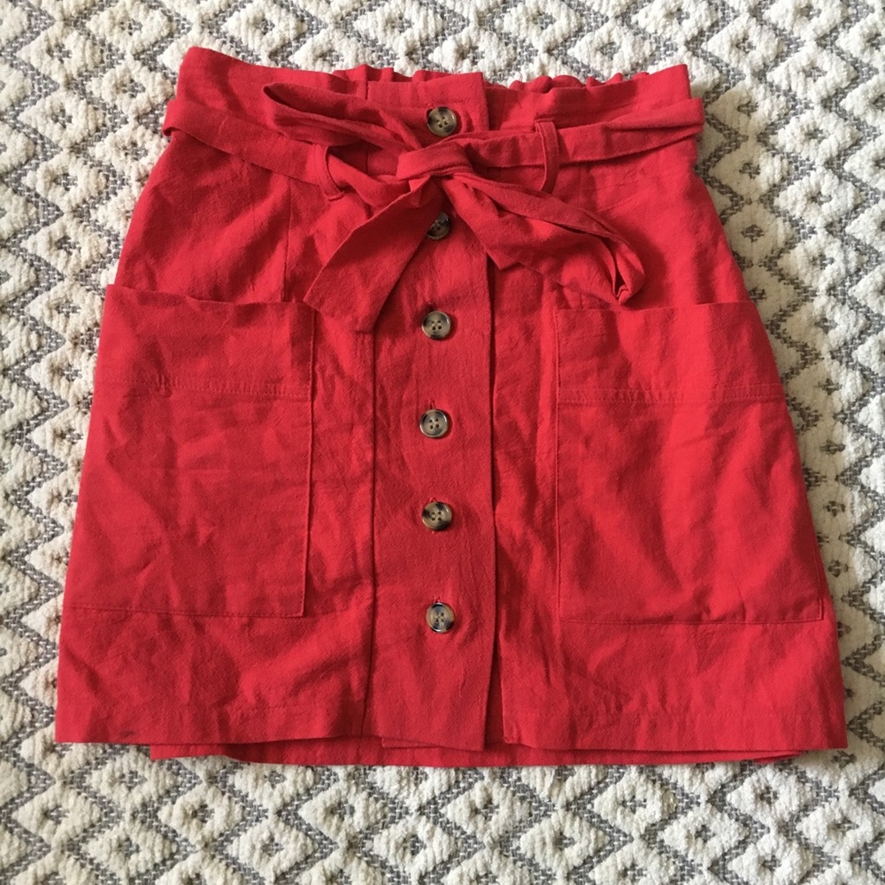 Red button up tie front paper bag skirt.